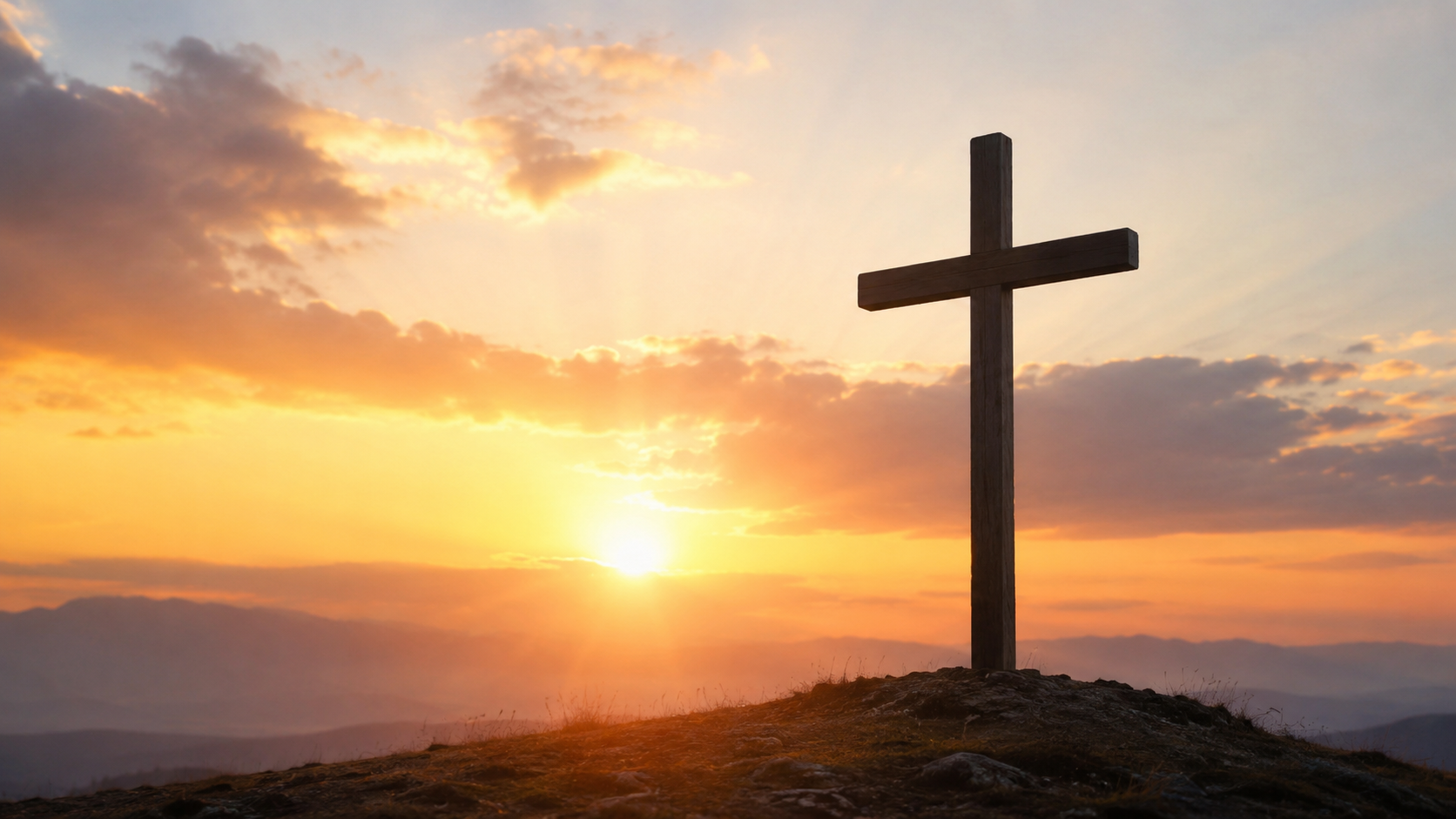 A wooden cross on a hilltop, silhouetted against a glowing sunrise sky